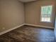 A bedroom with vinyl floors, neutral paint, and a window providing natural light at 609 Shiloh Unity Rd, Lancaster, SC 29720