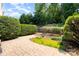 Paver patio with manicured garden featuring mature trees providing privacy at 6411 Aldworth Ln, Charlotte, NC 28226