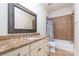 Bathroom with granite countertop, decorative mirror, shower and tub combination, and tile flooring at 6411 Aldworth Ln, Charlotte, NC 28226