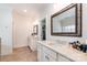 Elegant bathroom featuring double vanity with marble countertops, tile floor and large mirrors, plus a walk-in closet at 6411 Aldworth Ln, Charlotte, NC 28226