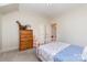 Bedroom with pink metal bed frame, wood dresser, neutral carpet, and white walls at 6411 Aldworth Ln, Charlotte, NC 28226