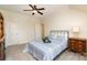 Comfortable bedroom with carpet, fan, closet, bedside table, blue and white bed linens, and natural light at 6411 Aldworth Ln, Charlotte, NC 28226