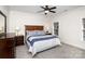 Cozy bedroom with ceiling fan, carpet, natural light from window, and wooden furniture set at 6411 Aldworth Ln, Charlotte, NC 28226