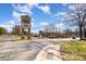 Shopping center entrance with visible retail signs and surrounding greenery at 6411 Aldworth Ln, Charlotte, NC 28226