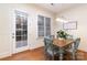 Cozy dining area with hardwood floors, natural light, and access to a patio at 6411 Aldworth Ln, Charlotte, NC 28226