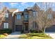 Charming brick townhome features a well-maintained lawn, attached garage and classic architectural details at 6411 Aldworth Ln, Charlotte, NC 28226