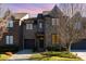 A charming two-story townhome with a landscaped yard, garage, and a warm and inviting entrance at 6411 Aldworth Ln, Charlotte, NC 28226