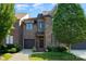 Charming brick townhome featuring an attached garage and manicured front lawn at 6411 Aldworth Ln, Charlotte, NC 28226