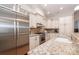 Stainless steel refrigerator in a kitchen with granite countertops and white cabinets at 6411 Aldworth Ln, Charlotte, NC 28226