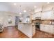 Bright kitchen with white cabinets, granite countertops, stainless steel appliances, and hardwood floors at 6411 Aldworth Ln, Charlotte, NC 28226