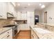 Features granite counters, stainless appliances, stylish backsplash and hardwood floors at 6411 Aldworth Ln, Charlotte, NC 28226