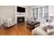 Inviting living room features a fireplace, hardwood floors, and large windows providing natural light at 6411 Aldworth Ln, Charlotte, NC 28226