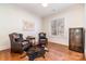 Bright office featuring hardwood floors, ample natural light, two leather chairs, decorative rug and built-in wine cooler at 6411 Aldworth Ln, Charlotte, NC 28226