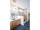 Elegant bathroom with double vanity, large shower, and dark-colored tile flooring at 8052 Cedarsmith Ct, Charlotte, NC 28217