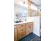 Bright bathroom featuring double sinks, a large shower, and light wood cabinets at 8052 Cedarsmith Ct, Charlotte, NC 28217
