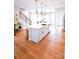 Bright kitchen features a large island with white cabinets, quartz countertops, and hardwood floors at 8052 Cedarsmith Ct, Charlotte, NC 28217