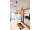 Modern kitchen island with quartz countertop, stainless steel sink, and gold pendant lights at 8052 Cedarsmith Ct, Charlotte, NC 28217