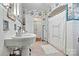 Clean bathroom with double vanity, tile, and floral wallpaper at 842 North Center St, Hickory, NC 28601
