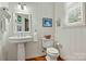 Classic bathroom with pedestal sink, toilet, and white wood walls at 842 North Center St, Hickory, NC 28601