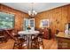 Bright dining room features wood walls, hardwood floors, and a charming round table with chairs at 842 North Center St, Hickory, NC 28601