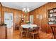Roomy dining area with wood walls, hardwood floors, and view into kitchen at 842 North Center St, Hickory, NC 28601