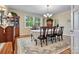 Formal dining room with hardwood floors, chandelier, and large windows at 842 North Center St, Hickory, NC 28601