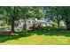 Beautiful white brick home with stone accents, situated on a lush green lawn at 842 North Center St, Hickory, NC 28601