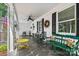 Inviting front porch with stone flooring, ceiling fan, and seating at 842 North Center St, Hickory, NC 28601