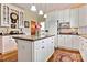 Updated kitchen with white cabinets, granite countertops and island at 842 North Center St, Hickory, NC 28601
