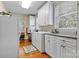 Bright laundry room with white cabinets and a side-by-side washer/dryer at 842 North Center St, Hickory, NC 28601