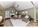 Vaulted ceiling living room with L-shaped sectional sofa and fireplace at 9100 Pine Springs Ct, Huntersville, NC 28078