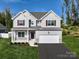 Two story house with gray siding, maroon shutters, and a white garage door at Lot 2 Glenview Meadow Dr # Savanh, Waxhaw, NC 28173