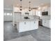 Kitchen with white cabinets, large island, and gray tile flooring at Lot 2 Glenview Meadow Dr # Savanh, Waxhaw, NC 28173