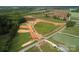 Birds-eye view showcasing road construction with equipment in a new development area; lush green surroundings at Lot 2 Glenview Meadow Dr # Savanh, Waxhaw, NC 28173