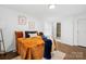 Bright bedroom with an orange comforter and access to a full bathroom at 1001 Archdale Dr, Charlotte, NC 28217