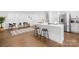 Modern kitchen with white cabinets, a large island, and stainless steel appliances at 1001 Archdale Dr, Charlotte, NC 28217