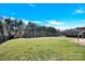 Large grassy backyard with a black metal fence at 1022 Torrens Dr # 4, Monroe, NC 28110