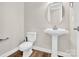 Clean bathroom with pedestal sink, toilet and wood-look floors at 1022 Torrens Dr # 4, Monroe, NC 28110