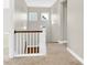 Upstairs hallway with carpeting and a wooden railing at 1022 Torrens Dr # 4, Monroe, NC 28110