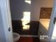 Bathroom with stone accent wall and wood flooring at 10244 Blakeney Preserve Dr, Charlotte, NC 28277