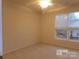 Neutral bedroom with a ceiling fan and a view from the window at 10244 Blakeney Preserve Dr, Charlotte, NC 28277