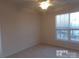 Spacious bedroom with large window and ceiling fan at 10244 Blakeney Preserve Dr, Charlotte, NC 28277