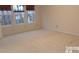 Bright bedroom with three windows and neutral colored carpet at 10244 Blakeney Preserve Dr, Charlotte, NC 28277