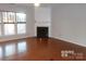 Living room with hardwood floors and corner fireplace at 10244 Blakeney Preserve Dr, Charlotte, NC 28277