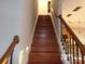 Wooden staircase with iron railing leading to the second floor at 10244 Blakeney Preserve Dr, Charlotte, NC 28277