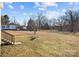 Large backyard with open space and mature trees at 104 E Main St, Cleveland, NC 27013