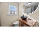 Stylish bathroom featuring a vessel sink, wood vanity, and large mirror at 104 E Main St, Cleveland, NC 27013