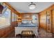 Bright bedroom with wood paneled walls, hardwood floors, and ample closet space at 104 E Main St, Cleveland, NC 27013