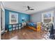 bedroom with wood floors, two windows, and colorful decor at 104 E Main St, Cleveland, NC 27013