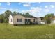 Charming yellow house with green lawn and a detached garage at 104 E Main St, Cleveland, NC 27013